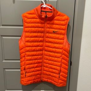 Orange Nike Golf Vest. Size Large. Inside and pockets fleece lined Hardly worn.